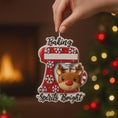 Load image into Gallery viewer, Personalized baking ornament featuring a festive red stand mixer design with snowflake details and a cute reindeer bowl accent. Finished with a smooth glossy surface and holiday inspired colors. Includes free handwritten personalization with one name and year displayed on the mixer. Designed with a raised 3D front and flat back for easy hanging. Styled in a cozy Christmas setting with snow greenery and ornaments, perfect for bakers home cooks and holiday keepsakes.