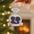 Load image into Gallery viewer, Ornament with silhouettes of a couple and flowers against a festive background