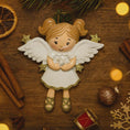 Load image into Gallery viewer, Decorative angel figurine with a baby on a wooden surface with Christmas decorations.