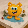 Load image into Gallery viewer, Yellow cartoon-like creature with blue shoes on a snowy surface with Christmas decorations.