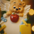 Load image into Gallery viewer, Decorative teacher angel figurine with a teddy bear head holding an apple, on a blurred background.