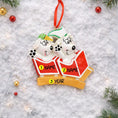 Load image into Gallery viewer, Personalized Christmas ornament with two dogs in red sweaters on a snowy background.
