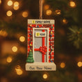 Load image into Gallery viewer, Decorative ornament with a door and tree, personalized with family name and year, against a blurred Christmas tree background.