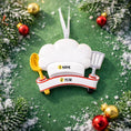 Load image into Gallery viewer, Personalized chef Christmas ornament featuring a white chef hat design with a wooden spoon and metal spatula details. Customized with a name and year on the front banner. Glossy resin finish with clean white and red accents creates a fun and professional cooking themed holiday look. Mostly 2D ornament with raised 3D details on the front only, lightweight and perfect for Christmas tree decor or kitchen themed gifts.