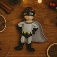 Load image into Gallery viewer, Personalized superhero boy Christmas ornament featuring a mask, cape and custom name. Cute holiday decor for boys, perfect for Christmas trees and gift-giving. Add name and year to create a unique keepsake. Display photos are AI-generated; please check the first image for the original product.