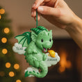 Load image into Gallery viewer, green dragon ornament designed with a fully sculpted 3D front that showcases raised details and expressive features, paired with a smooth 2D flat back for lightweight hanging. The glossy finish enhances the depth of the front design while keeping the back clean and minimal. Personalized name and year placement are clearly visible, making this dragon ornament a magical keepsake and a charming addition to holiday decor or fantasy themed collections.