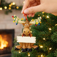 Load image into Gallery viewer, Moose ornament with Christmas lights held by a hand in front of a decorated Christmas tree.