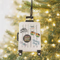 Load image into Gallery viewer, Decorative suitcase ornament with travel-themed phrases on a Christmas tree.