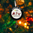 Load image into Gallery viewer, Personalized weightlifting and fitness Christmas ornament featuring a raised 3D front with bold circular design and red strength icons including boxing, gymnastics rings, and weightlifting. The ornament has a textured black outer rim and a flat 2D back for easy hanging. Includes a hanging kettlebell charm for added depth and movement. Hand-added personalization allows a name and year or family name. Photographed on a festive Christmas tree background with warm holiday lights.