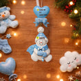 Load image into Gallery viewer, Decorative snowman ornament with customizable text on a wooden surface with Christmas decorations.
