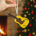Load image into Gallery viewer, Personalized guitar ornament featuring a classic acoustic guitar design with detailed strings and wood texture. Custom name and year handwritten directly on the guitar body. High detail 3D resin ornament with white hanging ribbon. Perfect Christmas tree decoration for guitar players musicians music lovers and acoustic guitar fans. Warm musical theme ideal for holiday decor and meaningful personalized gifts.