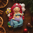Load image into Gallery viewer, Personalized mermaid Christmas ornament with red curly hair, teal seashell top and purple tail, custom name and year holiday keepsake