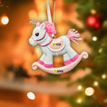 Load image into Gallery viewer, Unicorn-shaped ornament with customizable text on a blurred Christmas tree background