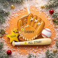 Load image into Gallery viewer, Personalized baseball glove Christmas ornament featuring a tan baseball glove with stitched details, customizable name area on the glove, customizable year star, and customizable text on the baseball bat, glossy finish with raised 3D front details and flat 2D back, white satin hanging ribbon, displayed on a snowy baseball field themed holiday background with baseballs and pine branches.