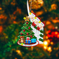 Load image into Gallery viewer, Personalized Christmas ornament with family of four and a tree, against a blurred festive background.