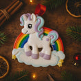 Load image into Gallery viewer, Unicorn ornament with rainbow on a wooden surface with Christmas decorations