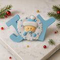 Load image into Gallery viewer, Decorative ornament with a baby face design on a 'JOY' letter, surrounded by Christmas decorations.