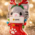 Load image into Gallery viewer, Christmas-themed cat ornament with customizable name and year text on a blurred lights background