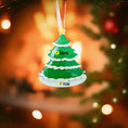 Load image into Gallery viewer, Green Christmas tree ornament with personalized text on a blurred festive background