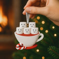 Load image into Gallery viewer, Decorative ornament of a teacup with smiling marshmallows and a candy cane against a festive background.