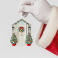 Load image into Gallery viewer, Decorative Christmas house ornament held by a gloved hand with a Santa Claus outfit.
