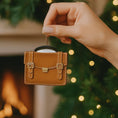 Load image into Gallery viewer, brown briefcase ornament on a green surface with Christmas decorations