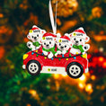 Load image into Gallery viewer, Christmas ornament with four polar bears in a red car with lights against a blurred festive background.