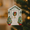 Load image into Gallery viewer, Decorative Christmas ornament shaped like a house with a wreath and trees on a blurred Christmas tree background.
