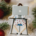 Load image into Gallery viewer, Decorative ornament of a person with a laptop on a stand, surrounded by Christmas decorations.