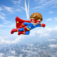 Load image into Gallery viewer, Superhero ornament with customizable name tag against a blue sky background