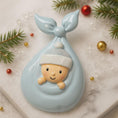 Load image into Gallery viewer, Decorative baby ornament in a blue cradle with Christmas decorations on a light background