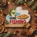 Load image into Gallery viewer, Decorative sign with 'Gone Fishing' text surrounded by Christmas decorations on a wooden background.