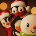 Load image into Gallery viewer, Decorative penguin figurines with festive attire against a blurred light background