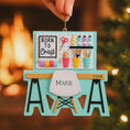 Load image into Gallery viewer, Born to Craft ornament featuring a creative desk scene with colorful craft supplies including scissors paint bottles brushes pencils and storage cups. The ornament showcases a playful crafting workspace design with a modern chair and desk setup. Made from durable resin with a detailed 3D front and flat 2D back for smooth hanging. Includes free handwritten personalization making it a perfect gift for crafters artists DIY lovers and creative kids. Ideal for Christmas trees craft rooms studios and handmade the