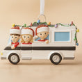 Load image into Gallery viewer, Decorative ornament of a family in a car with Christmas lights on a beige background