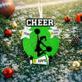 Load image into Gallery viewer, Personalized cheerleading Christmas ornament featuring a bright green glitter background with a cheer silhouette holding pom poms, bold CHEER title at the top, customizable name area on the lower banner, customizable year displayed on a star detail, and additional personalization space for school name or initials, glossy finish with raised 3D front elements and flat 2D back, white hanging ribbon, photographed on a snowy sports field themed holiday background with festive ornaments and winter greenery.