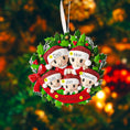 Load image into Gallery viewer, Personalized Christmas ornament with cartoon family in Santa hats on a holly wreath against a festive background.
