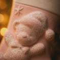 Load image into Gallery viewer, Close-up of a pink bath bomb ornament with glittery texture against a blurred background