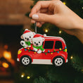 Load image into Gallery viewer, Personalized Christmas ornament featuring two polar bears wearing Santa hats riding in a red car decorated with colorful holiday lights. The ornament includes custom name personalization on each bear and a year displayed on the car. Designed with a detailed 3D raised front and smooth glossy finish, it is made for easy hanging on a Christmas tree. Perfect for festive holiday decor, couple ornaments, family keepsakes, and seasonal gift giving.
