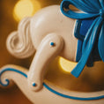 Load image into Gallery viewer, Close-up of a decorative elephant with a blue bow on a blurred background