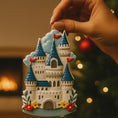 Load image into Gallery viewer, Personalized Princess Castle Christmas Ornament featuring a charming white fairytale castle with blue rooftops and red flags, surrounded by colorful floral details. Customizable with name at the base and year on the castle front, this magical princess castle ornament is perfect for celebrating a special little girl.