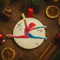 Load image into Gallery viewer, Colorful gymnast ornament on a wooden surface with Christmas decorations.