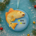 Load image into Gallery viewer, Decorative fish ornament with customizable text on a blue background with Christmas elements.