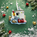 Load image into Gallery viewer, Decorative Christmas ornament of a small boat with tools on a green background with ornaments and snow.