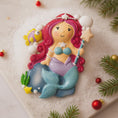 Load image into Gallery viewer, Personalized mermaid Christmas ornament with red curly hair, teal seashell top and purple tail, custom name and year holiday keepsake