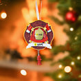 Load image into Gallery viewer, Decorative Christmas ornament with a fire hydrant and text on a blurred Christmas tree background.