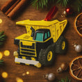 Load image into Gallery viewer, Yellow dump truck ornament on a wooden surface with Christmas decorations