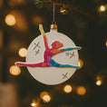 Load image into Gallery viewer, Colorful gymnast ornament on a Christmas tree with blurred lights in the background