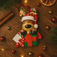 Load image into Gallery viewer, Christmas-themed reindeer ornament with lights on a wooden surface with decorations.