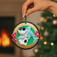 Load image into Gallery viewer, Personalized poker ornament featuring a cool shark character wearing sunglasses with playing cards and red casino chips. Designed in a round ornament style with a glossy finish. Includes free handwritten personalization with one name and year displayed on the front. Shown hanging with a ribbon in a festive holiday setting with greenery snow and seasonal decor. 3D raised front and flat back design perfect for Christmas trees and gifts for poker players casino lovers and card game fans.